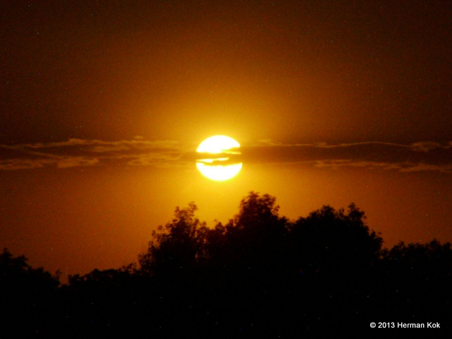 Full moon behind clouds