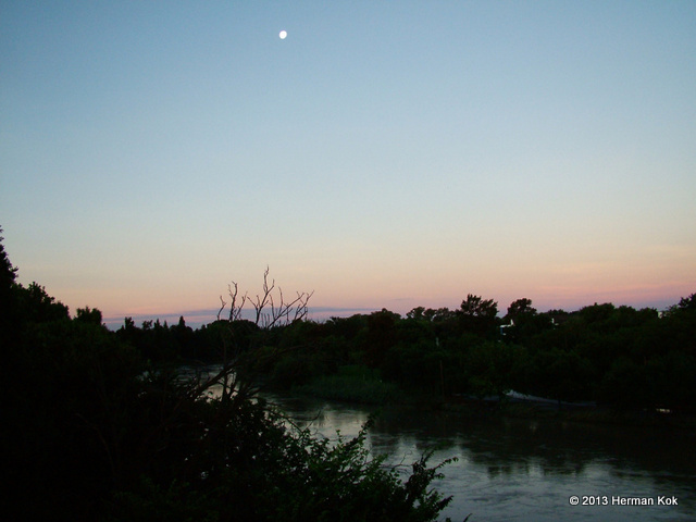 Moon over flooded river