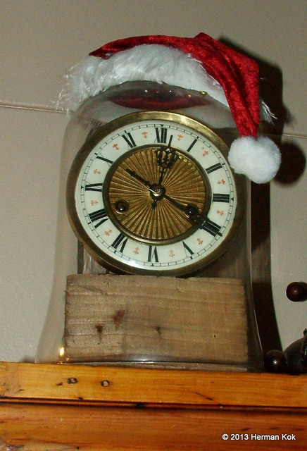 Clock under bell jar with santa hat