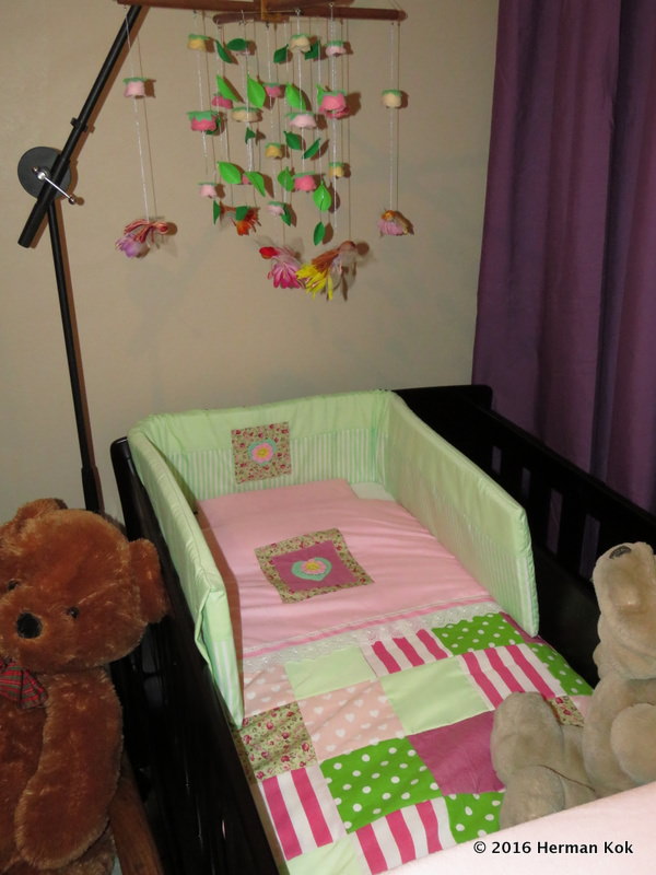 Cot with mobile above it